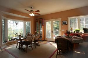 a living room with a dining room table and chairs at Inn to the Woods in Friday Harbor