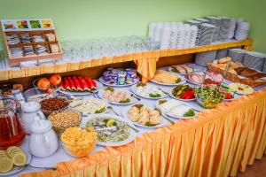 a buffet with many plates of food on a table at Villa Sylvia in Dźwirzyno +71 photos