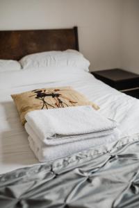 a pile of towels sitting on top of a bed at Hullidays - Victoria Dock Residence in Hull