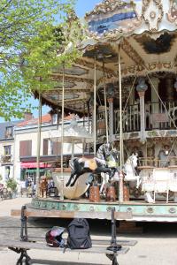 a trolley carousel with figurines on it in a city at Studio Plein Centre in Rambouillet
