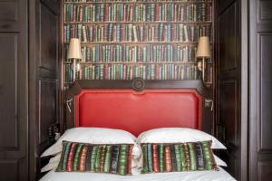 a bed room with a large bed and a book shelf at Serotel Lutèce in Paris