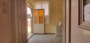 a hallway with an open door and a refrigerator at Apartments New Charming in Senj
