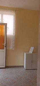 an empty room with a window and a refrigerator at Apartments New Charming in Senj