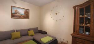 a living room with a couch and a clock on the wall at Apartments New Charming in Senj