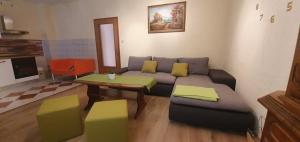 a living room with a couch and a table at Apartments New Charming in Senj