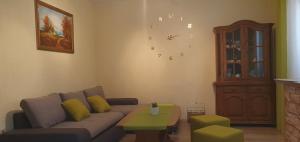 a living room with a couch and a clock on the wall at Apartments New Charming in Senj