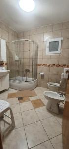 a bathroom with a shower and two toilets in it at Apartments New Charming in Senj