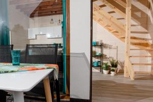 a kitchen and a living room with a table and a staircase at Molo Resort in Niechorze +33 photos