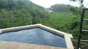 a swimming pool on the deck of a house at Radika Paradise Villa & Cottage in Tepus