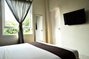 a bedroom with a bed and a window at Tuju WK Homes Syariah in Jakarta