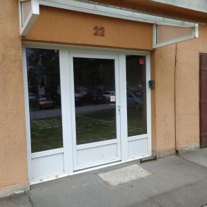 an entrance to a building with two glass doors at Krénusz Vendégház. in Kaposvár