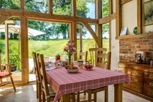 a dining room with a table with a table cloth on it at South Park Farm Barn in Andover