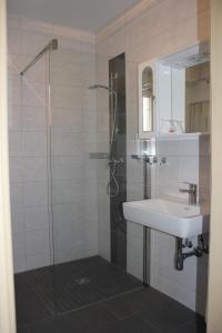 a bathroom with a glass shower and a sink at Gasthof zum Mohrn in Oberwölz Stadt