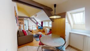 a living room with a table and chairs in a room at Studio Pelletiers, 4 personnes – City center in Strasbourg