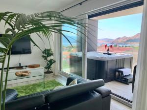 a living room with a couch and a large window at Villa Valis in Baška