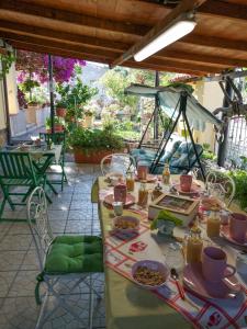 a table with plates of food on a patio at B&b il Giardino da Pina in Tuili +18 photos