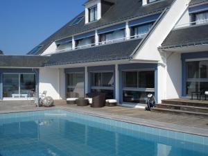 a house with a balcony and a pool at Le Cardinal - Belle-Ile-en-Mer in Sauzon