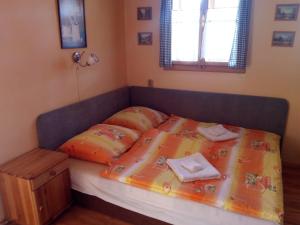 a bedroom with a bed with two pillows on it at Štúdio Liptovský Trnovec in Liptovský Trnovec