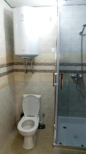 La salle de bains est pourvue d'une douche et de toilettes. dans l'établissement Maldives, à Vapniarka
