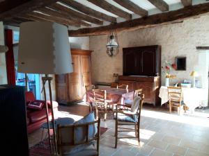 a living room with a dining room table and chairs at Gite rural DUNAND in Tournon-Saint-Martin