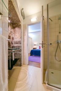a bathroom with a shower and a bedroom at Casa de Campo Monte Abades in Terras de Bouro