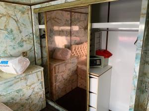 a small room with marble walls and a glass door at Vintage, Circus Holiday Home in Mablethorpe +16 photos