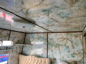 a ceiling in a room with a marble wall at Vintage, Circus Holiday Home in Mablethorpe
