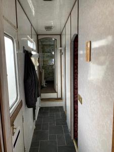a hallway in a train with a door and a tile floor at Vintage, Circus Holiday Home in Mablethorpe