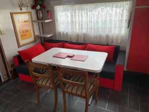 a table and chairs in a room with a couch at Vintage, Circus Holiday Home in Mablethorpe