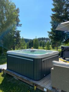 a hot tub sitting on top of a deck at Norrfly Herrgård in Kilafors