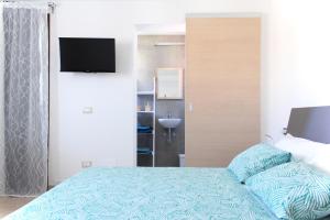 Postel nebo postele na pokoji v ubytování Acquachiara Rooms