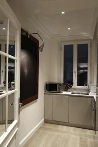 a kitchen with a sink and a microwave at Lungarno Luxury Apartments - by Lungarno Collection in Florence