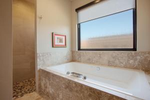 a bath tub in a bathroom with a window at Red Rock in St. George