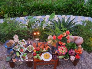 a table full of fruits and vegetables on a bench at Sapa Clay House - Mountain Retreat in Sapa
