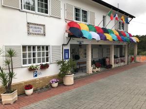 a building with umbrellas on the side of it at Residencial Celeste in Águeda