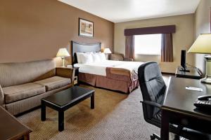 a hotel room with a bed and a desk at Baymont by Wyndham Decatur in Decatur