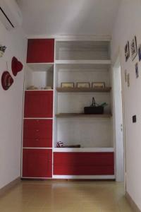 a room with red shelves in a room at Casa Azzurra in Conca Specchiulla
