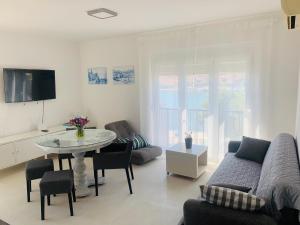 uma sala de estar com um sofá e uma mesa em Trogir Penthouse IVY em Trogir