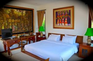 A bed or beds in a room at Aqua Octaviana Bali Villa