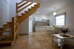 a kitchen and a living room with a staircase at Veroma in Ostrowo