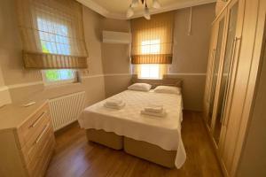 a bedroom with a bed with two towels on it at Villa Acar - 4 Bedroom Villa in Dalyan Center, Private Pool&Garden in Mugla +34 photos