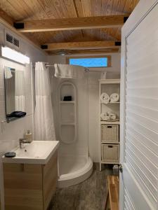 a bathroom with a sink and a tub and a toilet at Deer Run on the Atlantic in Big Pine Key