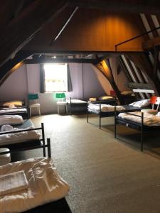 a room with several bunk beds in a attic at Antwerp City Hostel in Antwerp