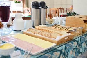 a table with several slices of bread and cheese at Hotel do Valle in Tijucas