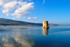 a lighthouse in the middle of a large body of water at Affittacamere orbetello centro in Orbetello