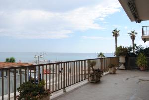 a balcony with a view of the beach at Gaiavacanze Beach Apartment in Bordighera