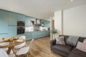 a kitchen and living room with a table and a couch at 12 Pear Tree House in York