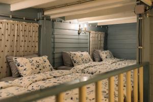 two bunk beds in a room with a bed frame at Lhong Yaowarat hostel in Bangkok