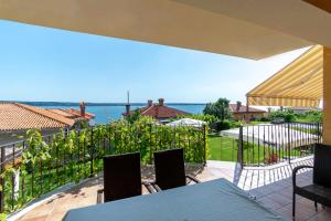 a balcony with a table and chairs and the ocean at Apartments Apartim Piran in Piran