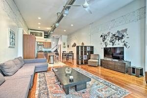 a living room with a couch and a coffee table at Nulu Art District Loft Walk to Dtwn Distilleries! in Louisville